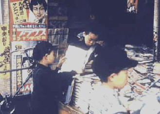 Kids reading comic books at news stand in Sendai